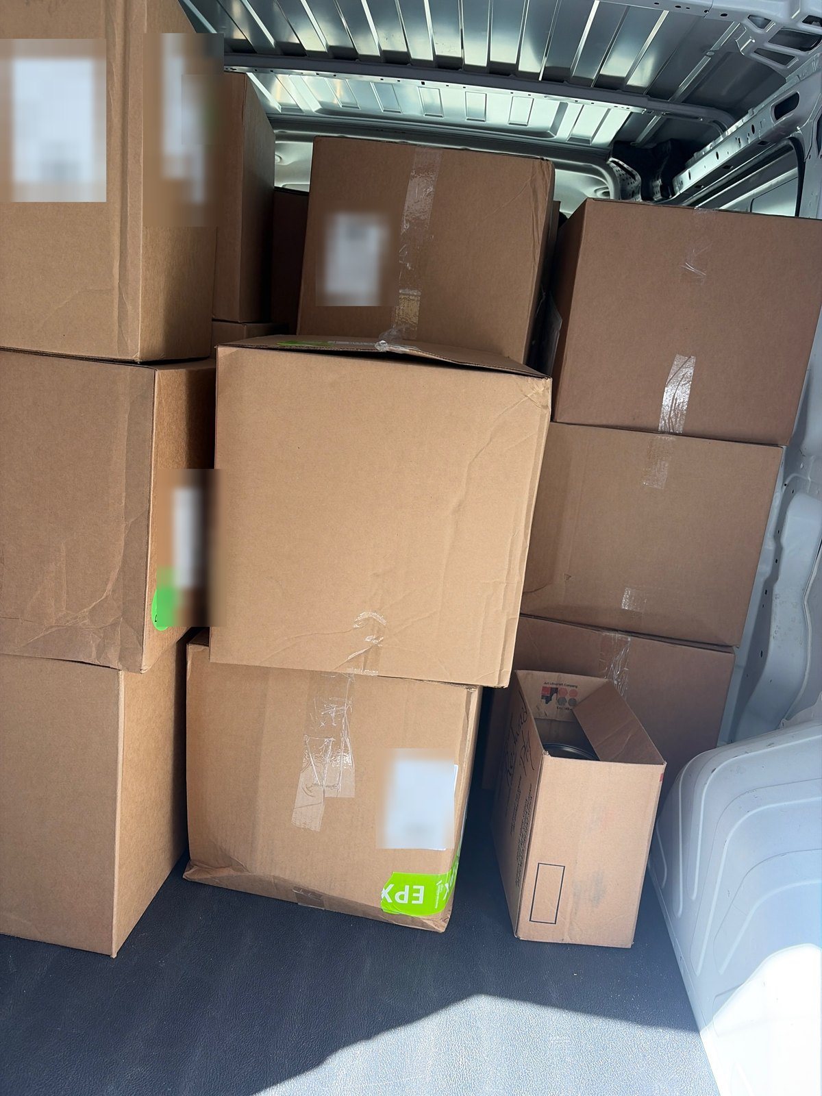 The client's own frame, taped cartons stacked and ready to run — the second supplied portrait file, used as documentary proof